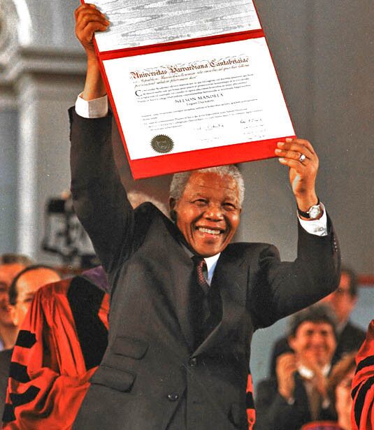 President Nelson Mandela shows off his just-received honorary degree from Harvard University on Sept. 18, 1998.