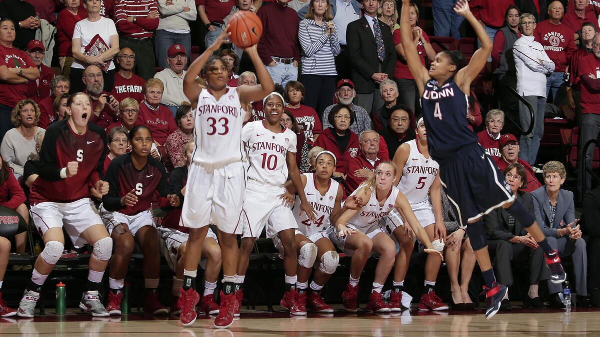 Stanford guard Amber Orrange makes a three-pointer over Connecticut guard Moriah Jefferson to send the game into overtime during the Cardinal's 88-86 win Monday.