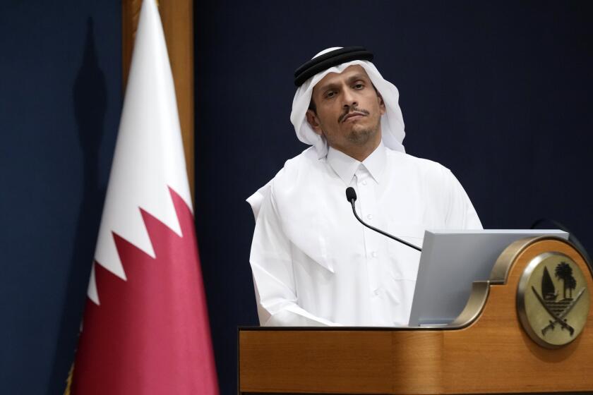 FILE - Qatar's Prime Minister and Foreign Minister Mohammed bin Abdulrahman Al Thani listens a question with U.S. Secretary of State Antony Blinken in Doha, Qatar, Friday Oct. 13, 2023. Qatar is the go-to mediator in the Israel-Hamas war. On Saturday, Nov. 25, 2023, a Qatari jet landed in Israel's Ben-Gurion International Airport with an urgent task: save the cease-fire deal between Israel and Gaza's Hamas rulers. (AP Photo/Jacquelyn Martin, Pool, File)