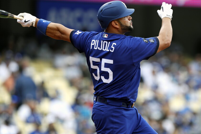 The Dodgers' Albert Pujols follows through after hitting a solo home run against the New York Mets.