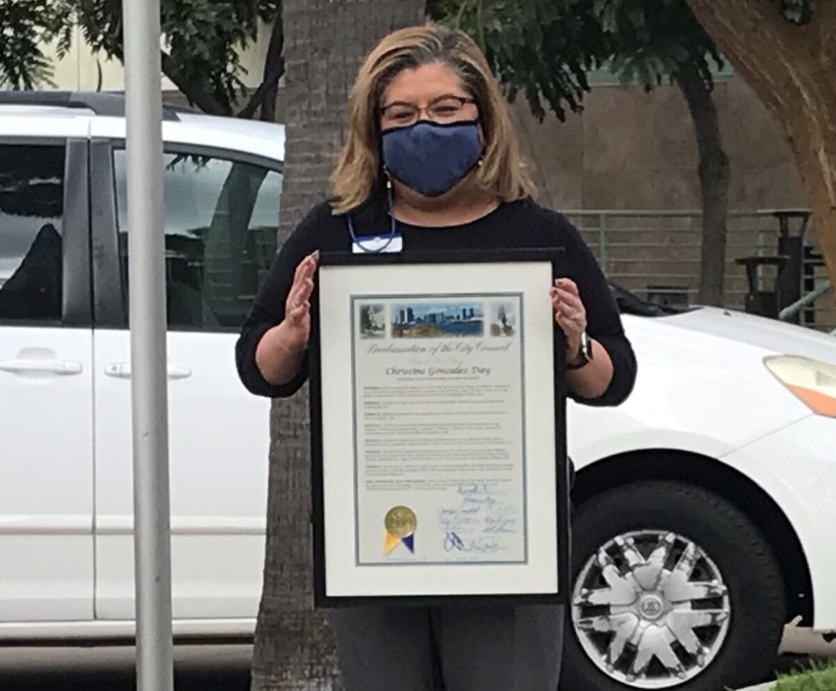 Point Loma/Hervey Library branch manager Christine Gonzalez holds San Diego's proclamation of Christine Gonzalez Day.