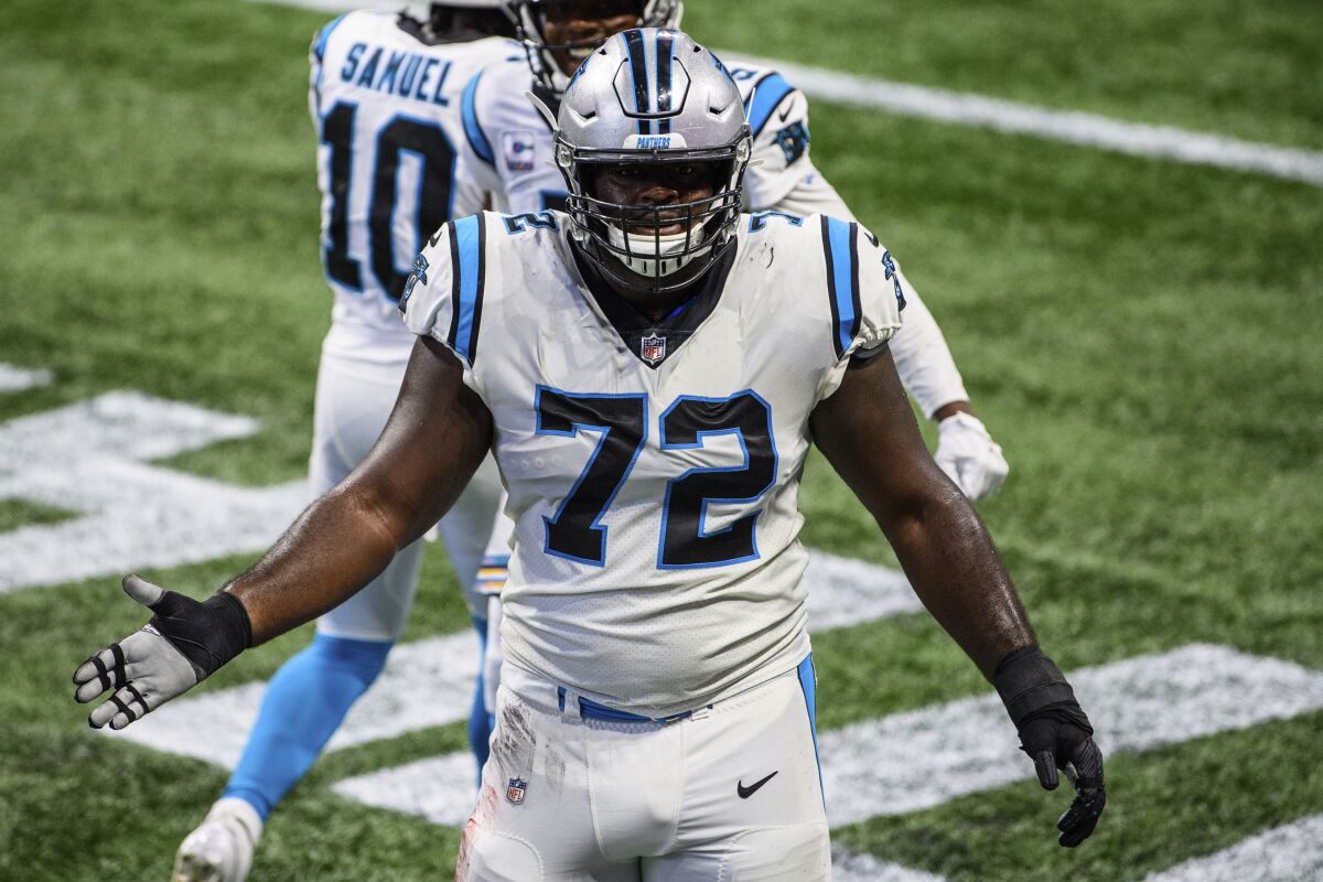 FILE - In this Sunday, Oct. 11, 2020 file photo, Carolina Panthers offensive tackle Taylor Moton (72) reacts during the first half of an NFL football game against the Atlanta Falcons in Atlanta. The Carolina Panthers have agreed to a four-year contract extension with offensive tackle Taylor Moton narrowly beating the deadline to sign players with the franchise tag to a contract extension, according to a person familiar with the situation. The person spoke to The Associated Press on Thursday, July 15, 2021 on condition of anonymity because the team has not yet announced the contract. (AP Photo/Danny Karnik, File)