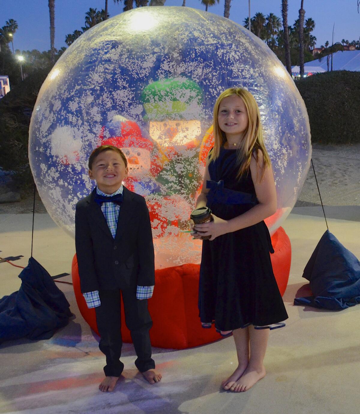 Kea Robb, 9, with brother Kam, 5, attend the Newport Dunes & Waterfront Resort Lighting of the Bay on Friday.