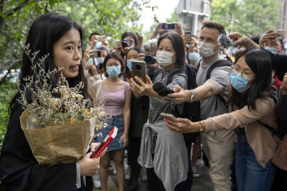 Zhou Xiaoxuan, a former intern at China's state broadcaster CCTV, speaks outside a courthouse before attending a session in her court case against a television host she accuses of groping and forcibly kissing her in Beijing, Tuesday, Sept. 14, 2021. Zhou became the face of the country's MeToo movement after going public with accusations against a prominent CCTV host in 2018. Since then, even as the movement was shut down by authorities, Zhou has continued to speak out. (AP Photo/Mark Schiefelbein)
