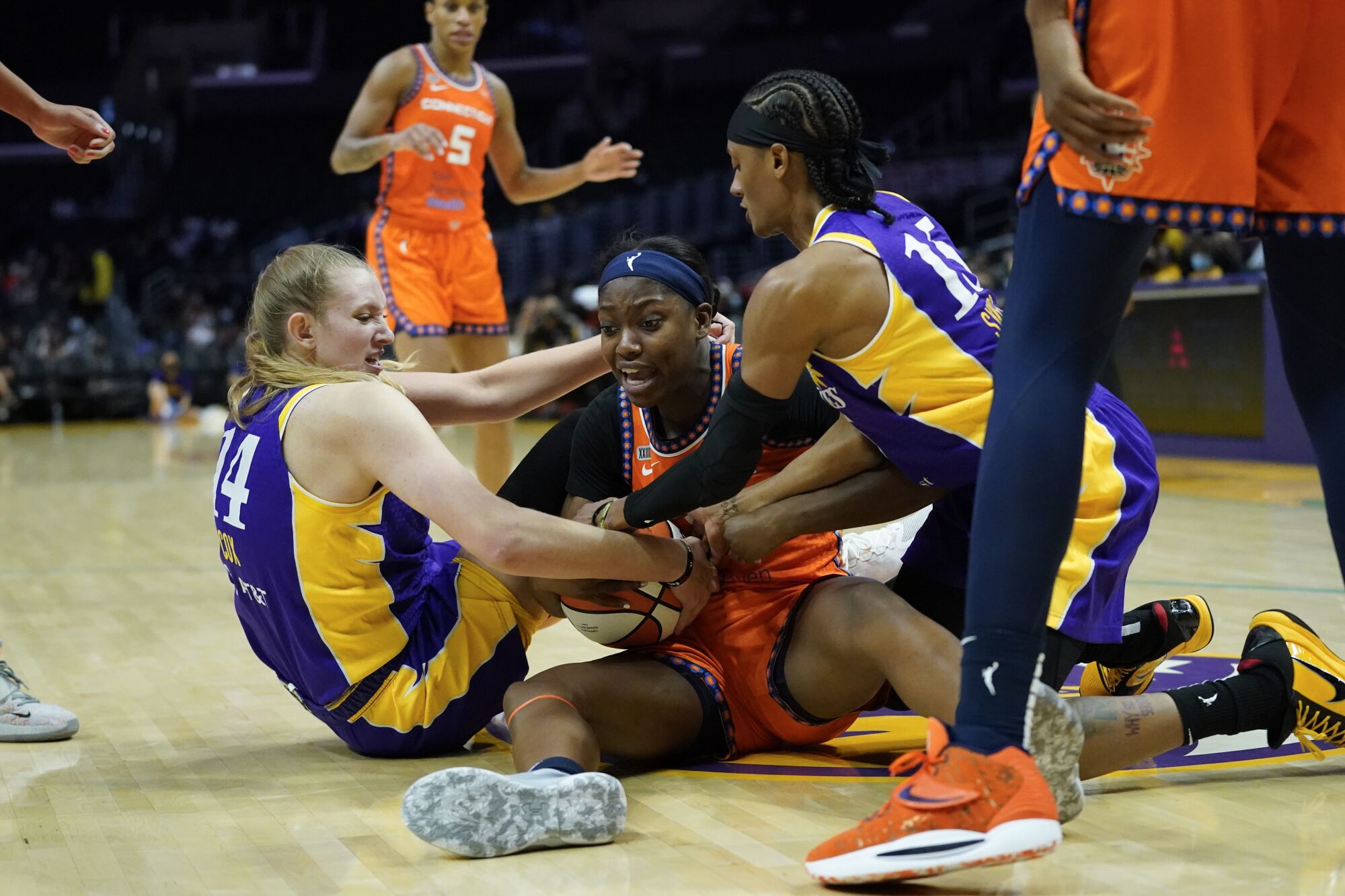 Sparks guard Brittney Sykes, right, and forward Lauren Cox battle for a loose ball with Sun forward Kaila Charles.