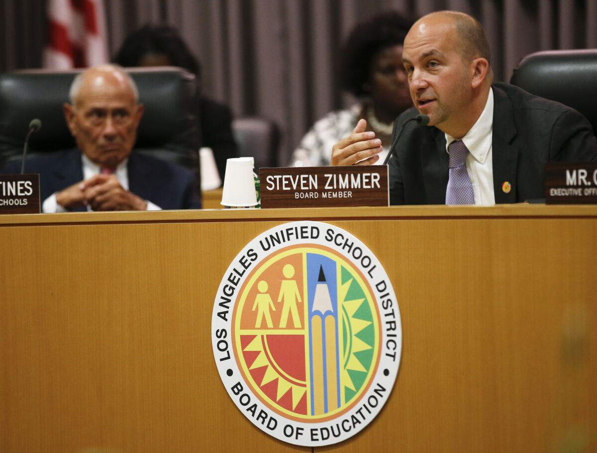 L.A. Unified board President Steven Zimmer addresses fellow board members as outgoing Supt. Ramon C. Cortines looks on during the annual meeting at district headquarters July 1.