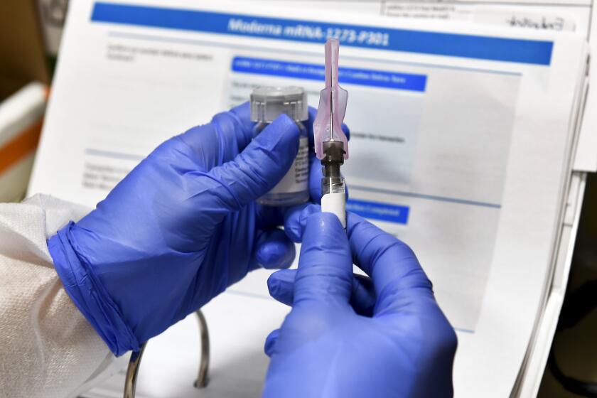 FILE - In this July 27, 2020, file photo, nurse Kathe Olmstead prepares a shot that is part of a possible COVID-19 vaccine, developed by the National Institutes of Health and Moderna Inc., in Binghamton, N.Y. Moderna said Monday, Nov. 16, 2020, its COVID-19 shot provides strong protection against the coronavirus that's surging in the U.S. and around the world. (AP Photo/Hans Pennink, File)