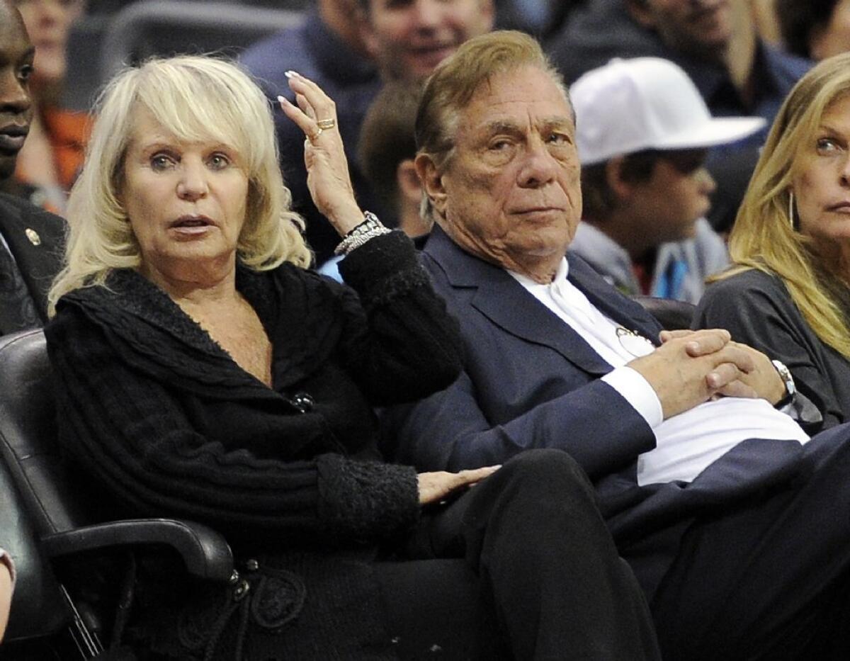 Donald Sterling, right, sits with his wife, Shelly, during a Clippers game in 2010 in Los Angeles.