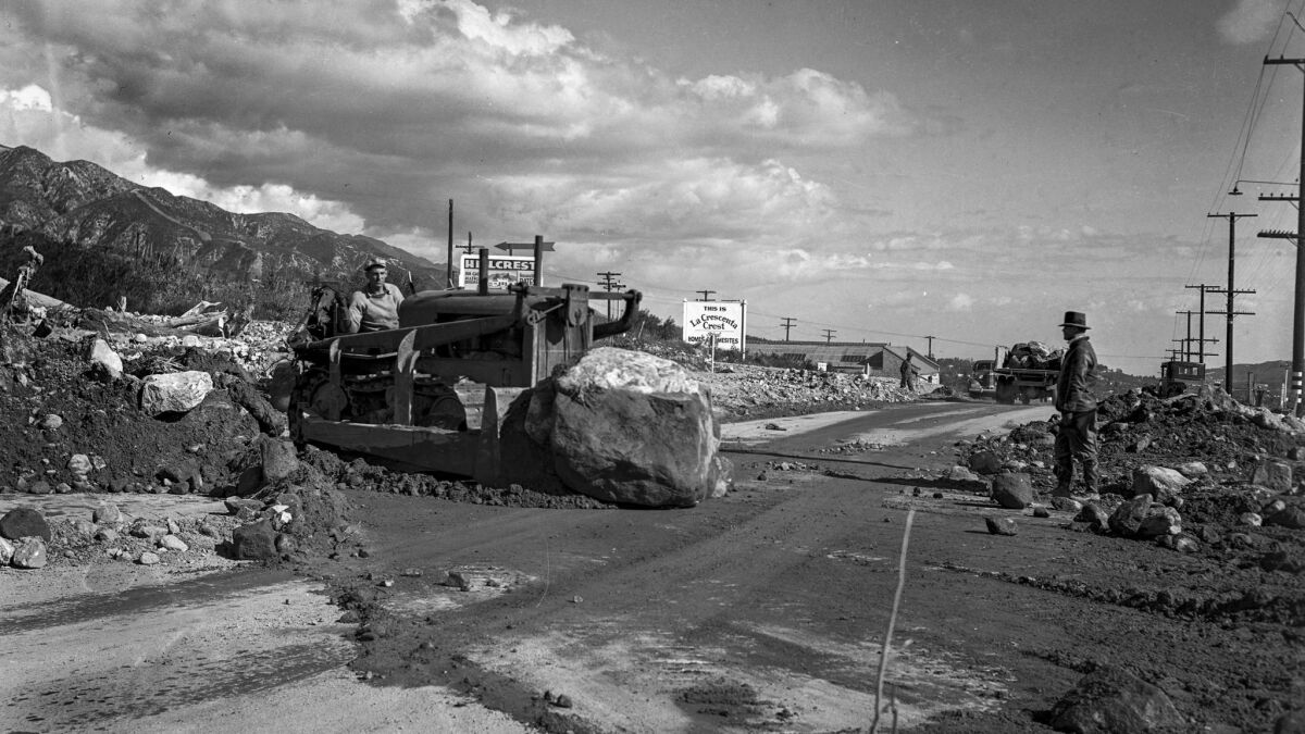 March 4, 1938: Workers remove debris from Foothill Boulevard at Lowell Street near Tujunga.