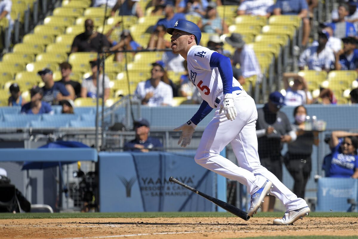 Dodgers first baseman Freddie Freeman watches his solo home run in the sixth inning Sunday against the Chicago Cubs.