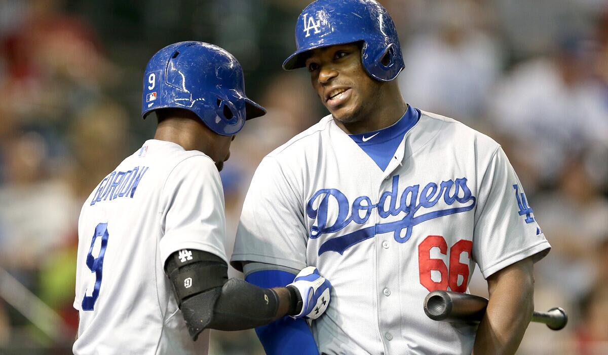 Dodgers center fielder Yasiel Puig (66) chats with second baseman Dee Gordon in the on-deck circle before the first inning of their game against the Diamondbacks on Tuesday in Arizona.