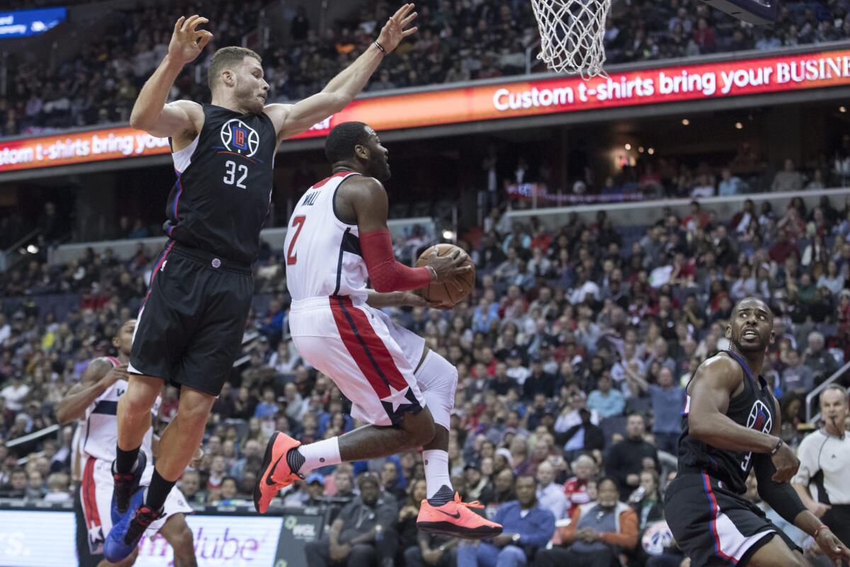 Clippers forward Blake Griffin tries to block a layup by Wizards guard John Wall during the second half of Sunday's game.