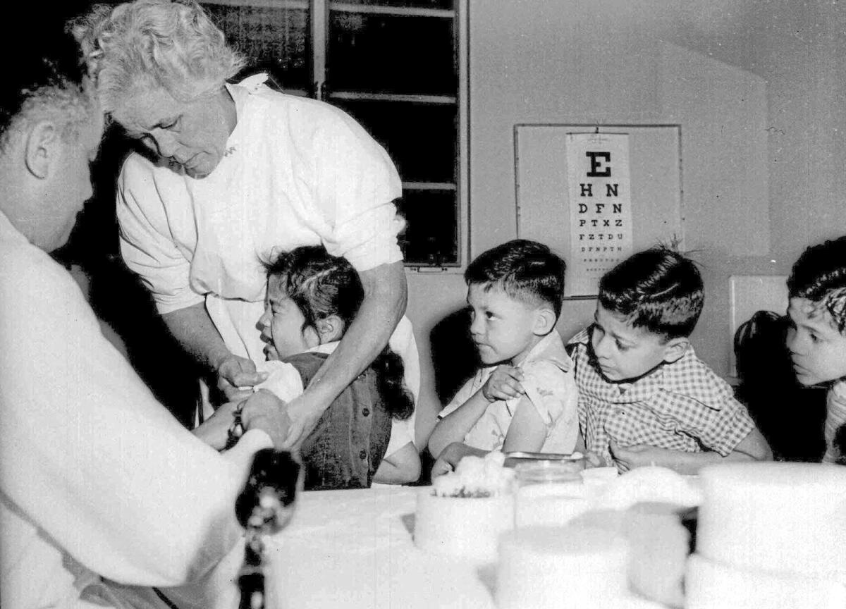 First- and second-graders in Los Angeles line up to receive the polio vaccine in 1955.