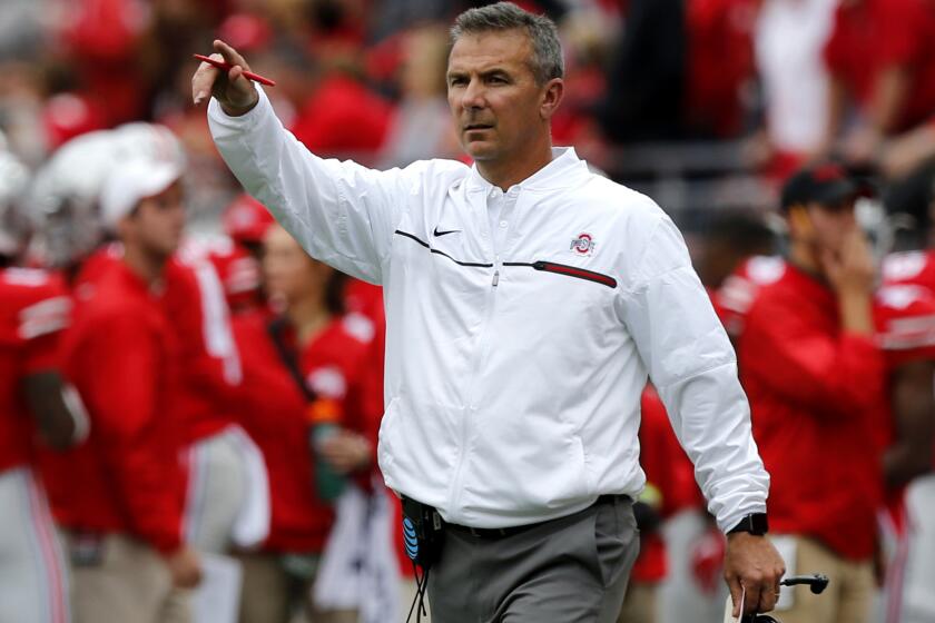 Ohio State Coach Urban Meyer gives instructions to his players during a win over Rutgers on Saturday.