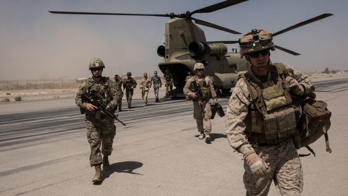 U.S. service members walk off a helicopterat Camp Bost in Helmand Province, Afghanistan.