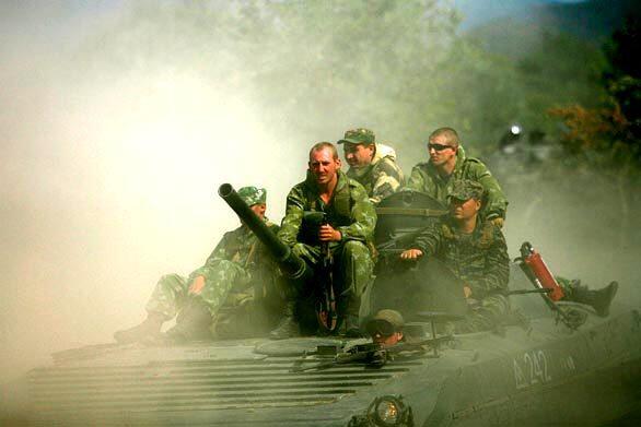 Russian soldiers ride on the road from Tbilisi to Gori, Georgia. According to reports, Russia has begun to withdraw its missiles, tanks and troops from central Georgia after criticism from Western leaders.