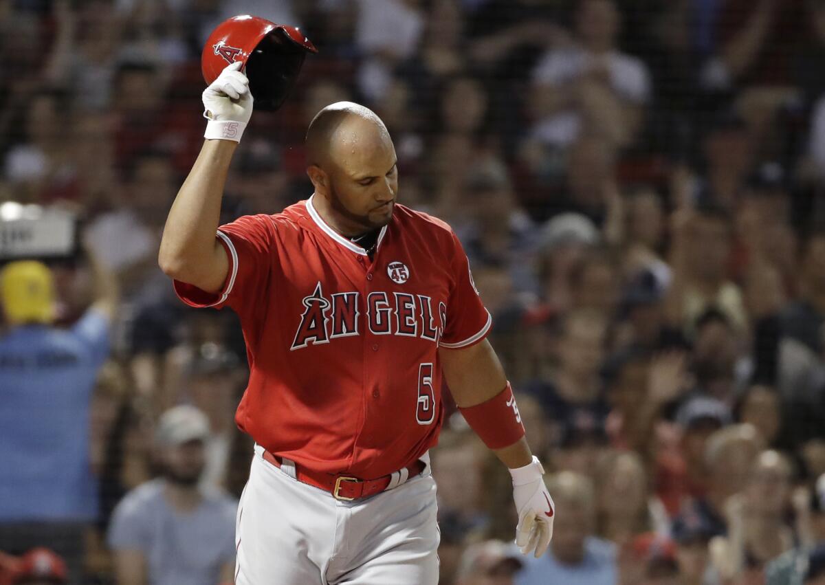 Angels' Albert Pujols tosses his helmet after striking out against Boston Red Sox starting pitcher Chris Sale during the seventh inning on Thursday in Boston. 