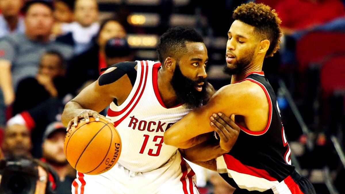 Rockets guard James Harden looks to drive against Trail Blazers guard Allen Crabbe during their game Wednesday night in Houston.