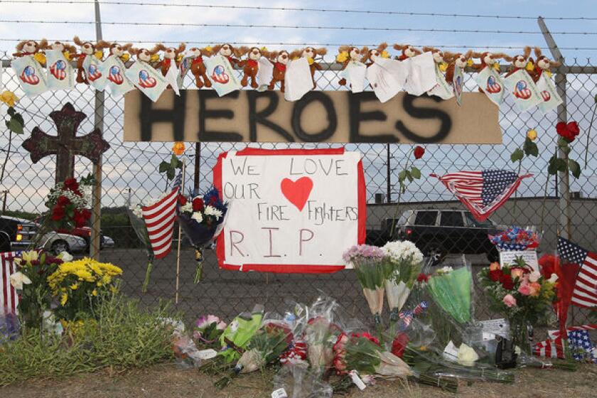 A makeshift memorial and a sign reading "Heroes" is displayed outside of Station 7 in Prescott, Ariz., which housed the Granite Mountain Interagency Hotshot Crew.