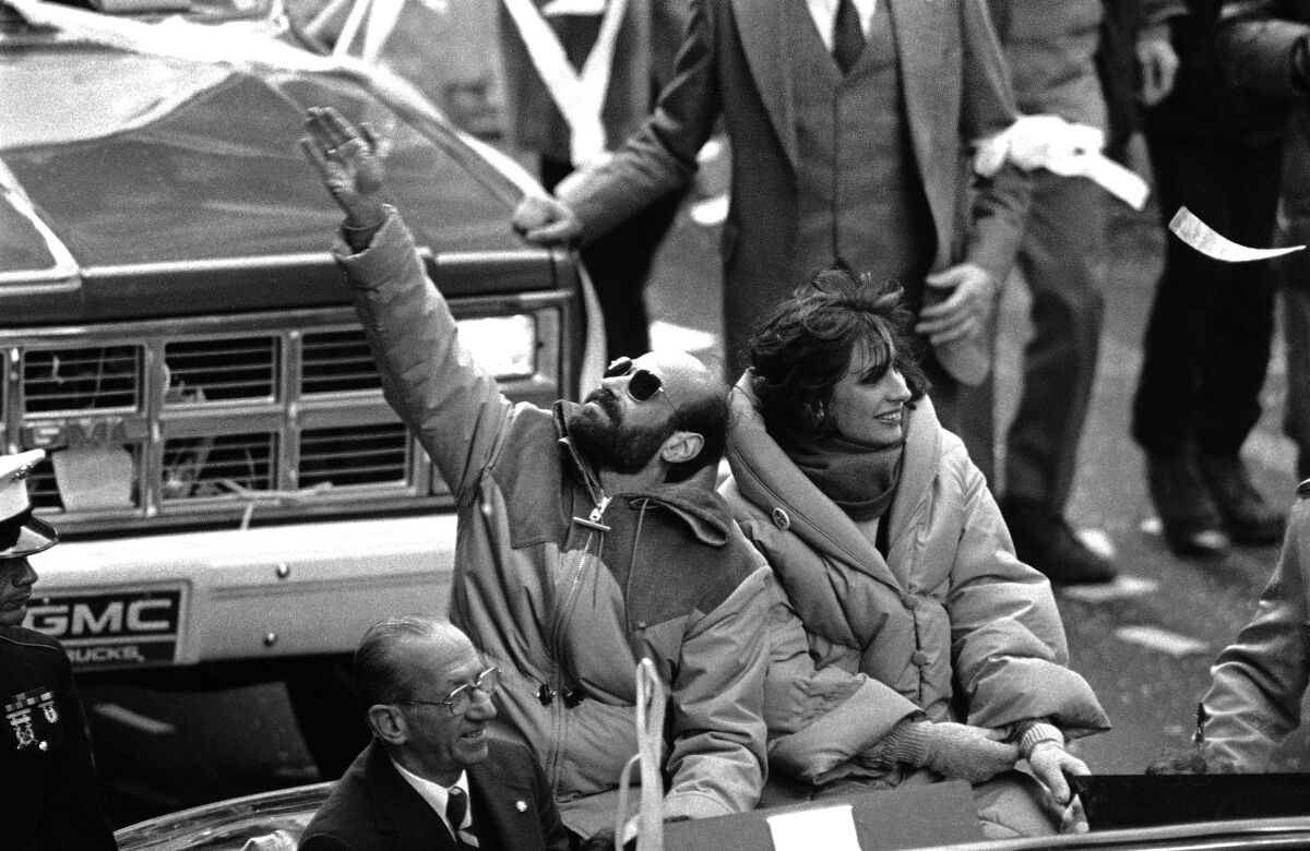 Former hostage Barry Rosen, with wife Barbara, waves as thousands cheer at a welcoming parade in New York on Jan. 30, 1981.
