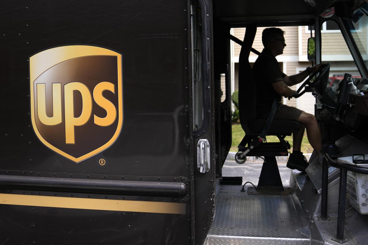 A UPS truck with a driver inside