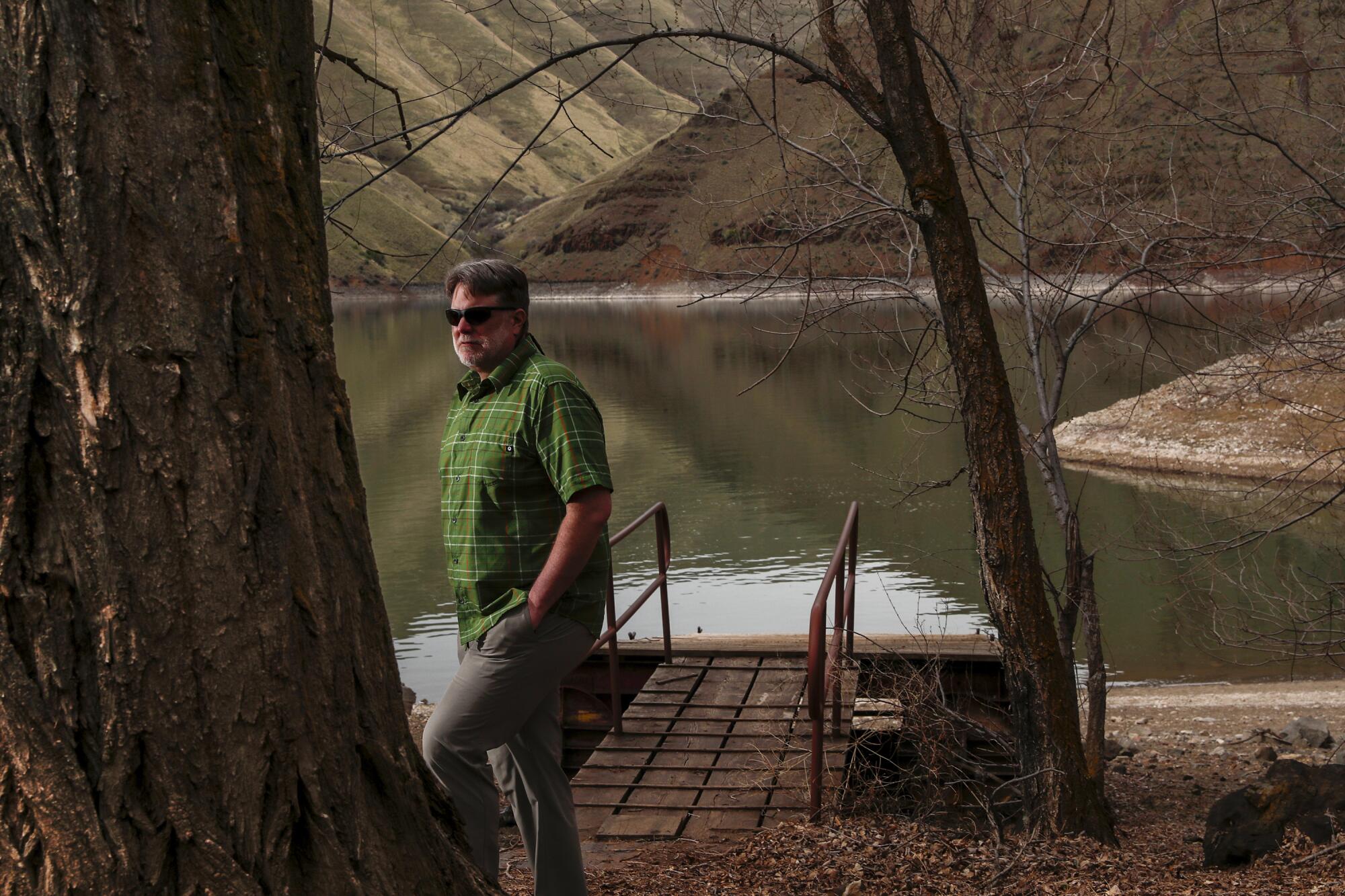 A man stands on the shore of Brownlee Reservoir on the Snake River.