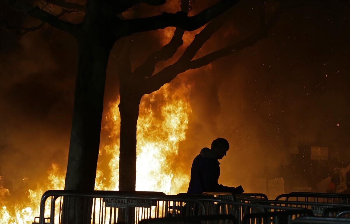 A bonfire set by demonstrators protesting a scheduled appearance by Breitbart News editor Milo Yiannopoulos at UC Berkeley.