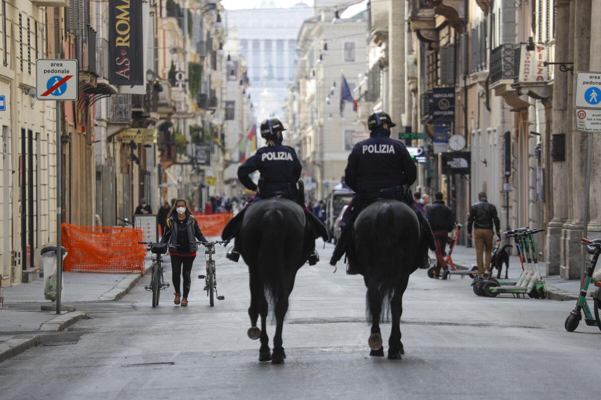 Mounted police officers patrol Via del Corso main shopping street.