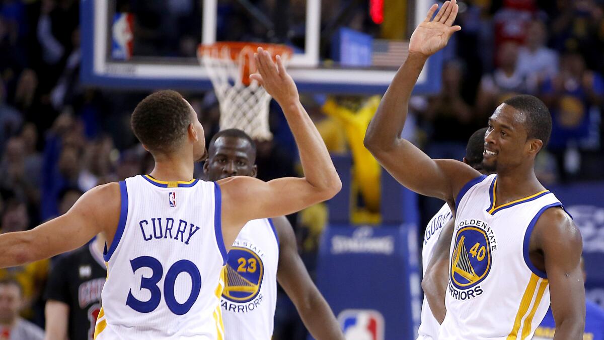 Warriors forward Harrison Barnes (40) celebrates a three-pointer with point guard Stephen Curry during the second half Friday night.