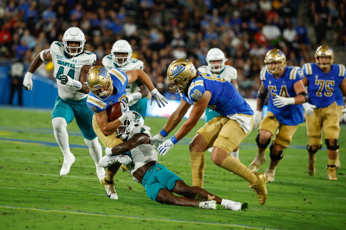 UCLA wide receiver Ryan Cragun is tackled after making a catch against Coastal Carolina on Saturday.
