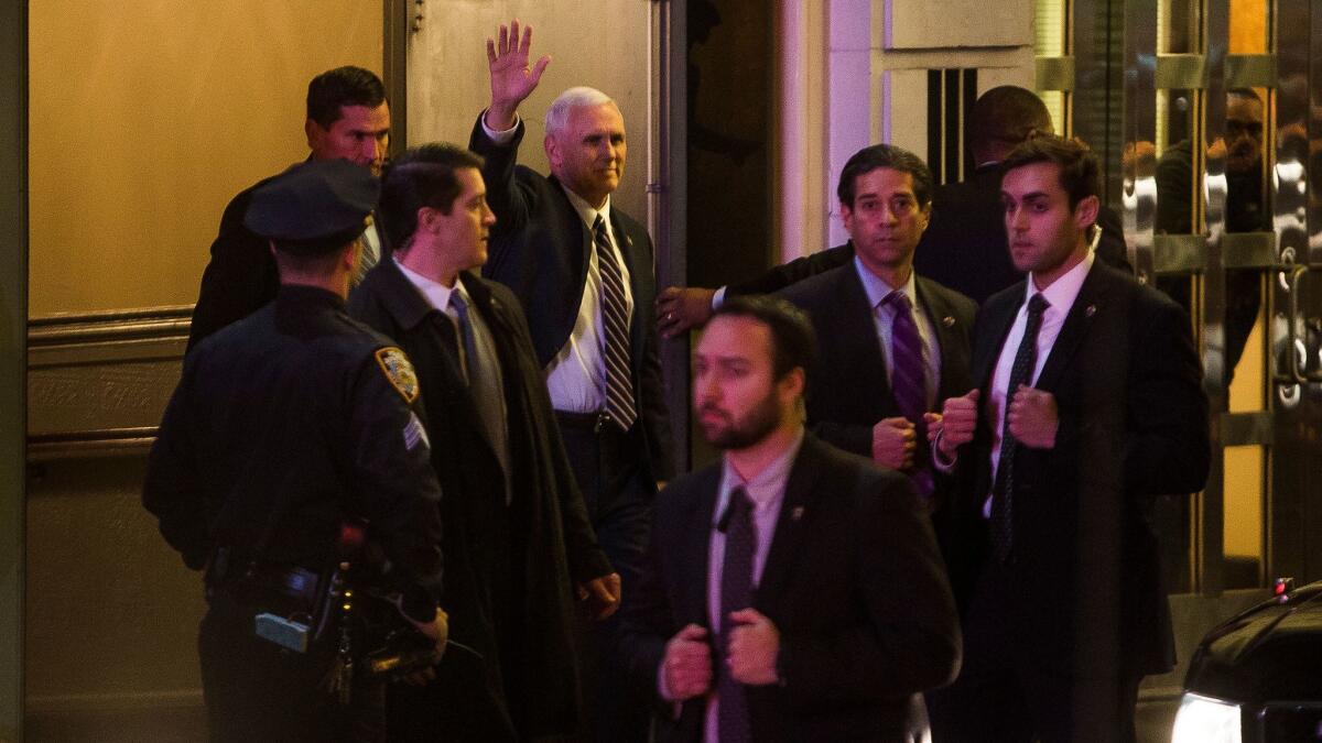 Vice President-elect Mike Pence, top center, leaves the Richard Rodgers Theatre after seeing "Hamilton" on Friday in New York.