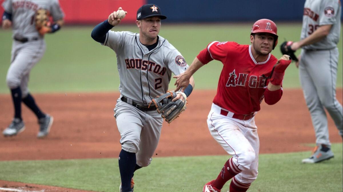 Houston Astros third baseman Alex Bregman chases David Fletcher during a rundown in the third inning of the Angels' 10-4 loss at Monterrey, Mexico.