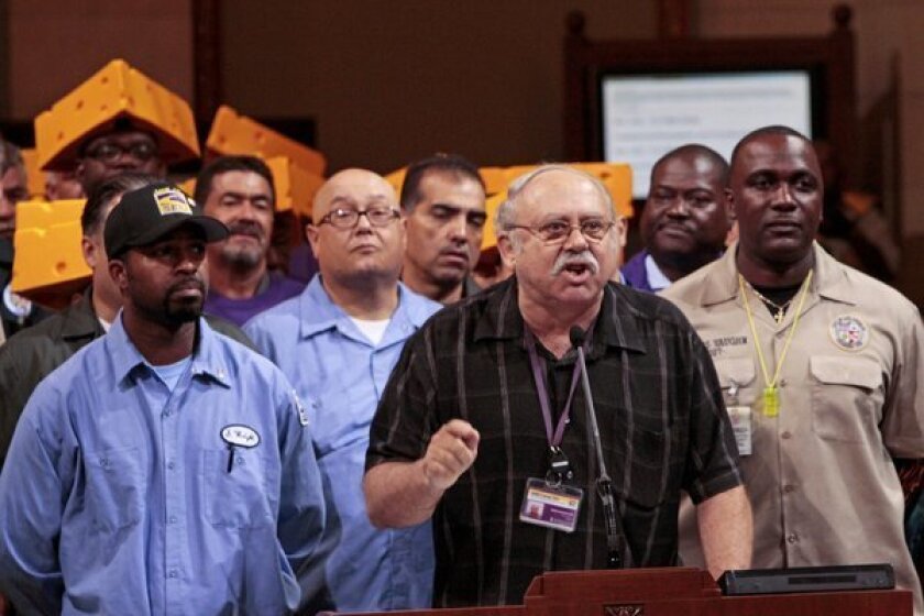 Surrounded by city workers in September, SEIU Local 721 President Bob Schoonover, center, addresses the Los Angeles City Council to protest cuts to future city workers' retirement and health benefits.