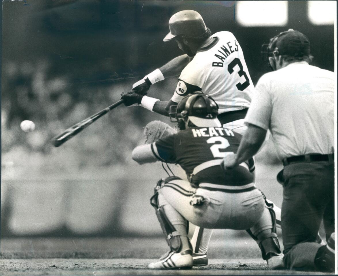 A's catcher Mike Heath awaits the ball, but the White Sox's Harold Baines had already sent it on its way over the left-field wall for a two-run homer in a 6-4 victory. on June 2, 1984.