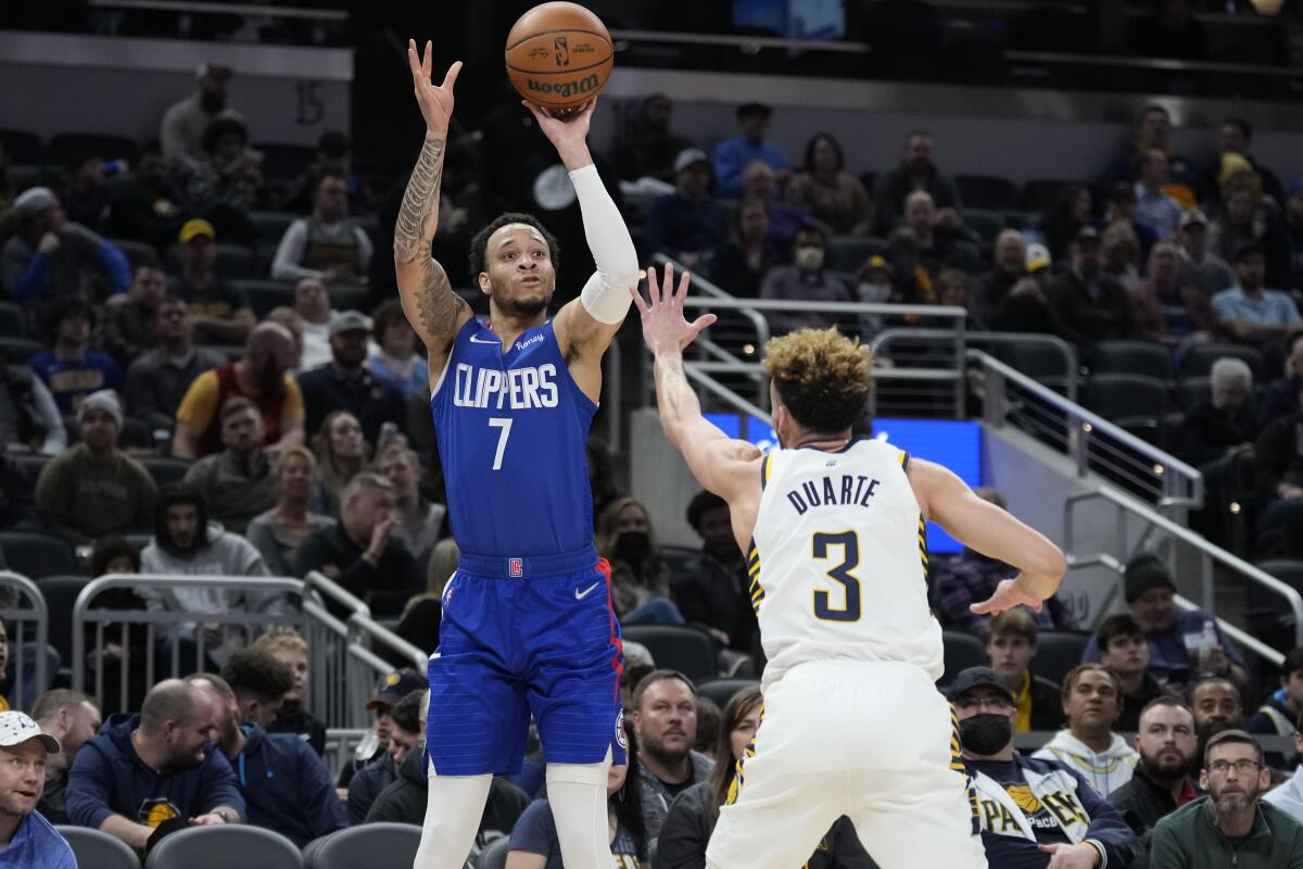 Amir Coffey shoots over Pacers guard Chris Duarte in the second half.