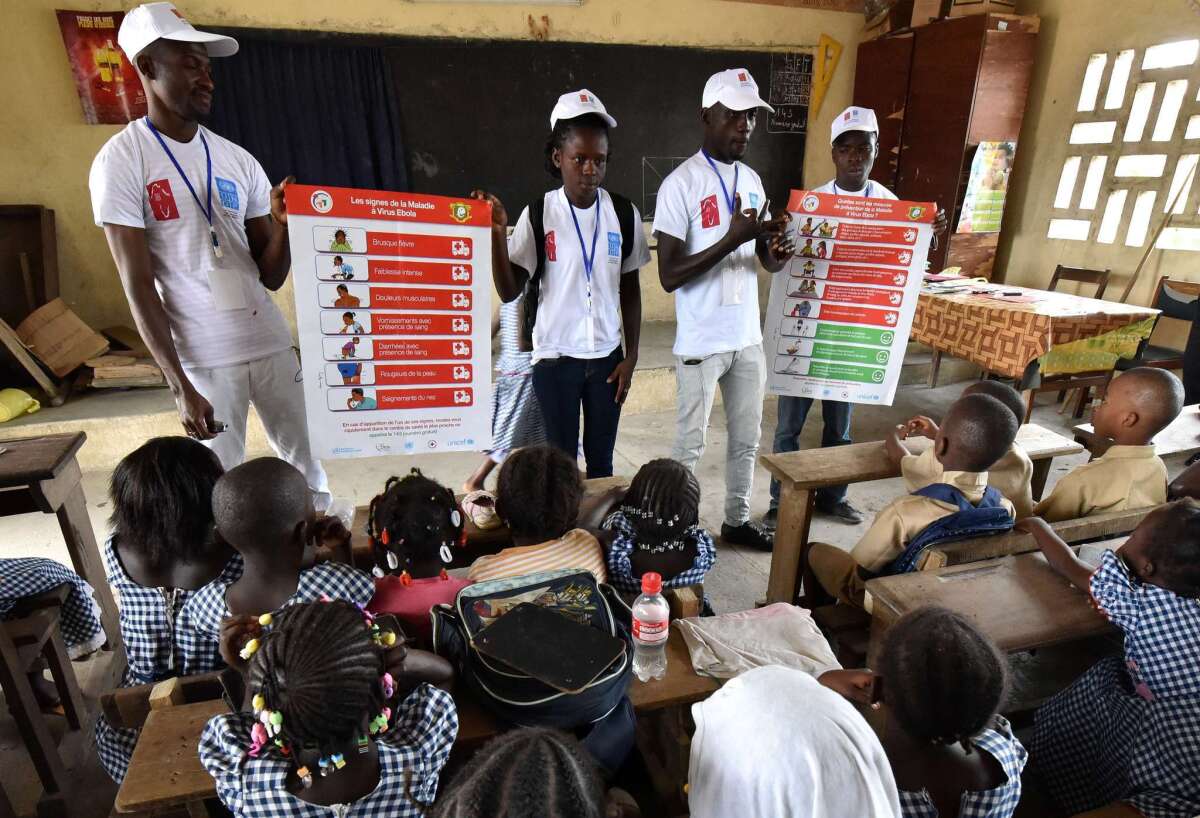 Students with an Ebola prevention poster as part of a United Nations program in Ivory Coast on Monday.