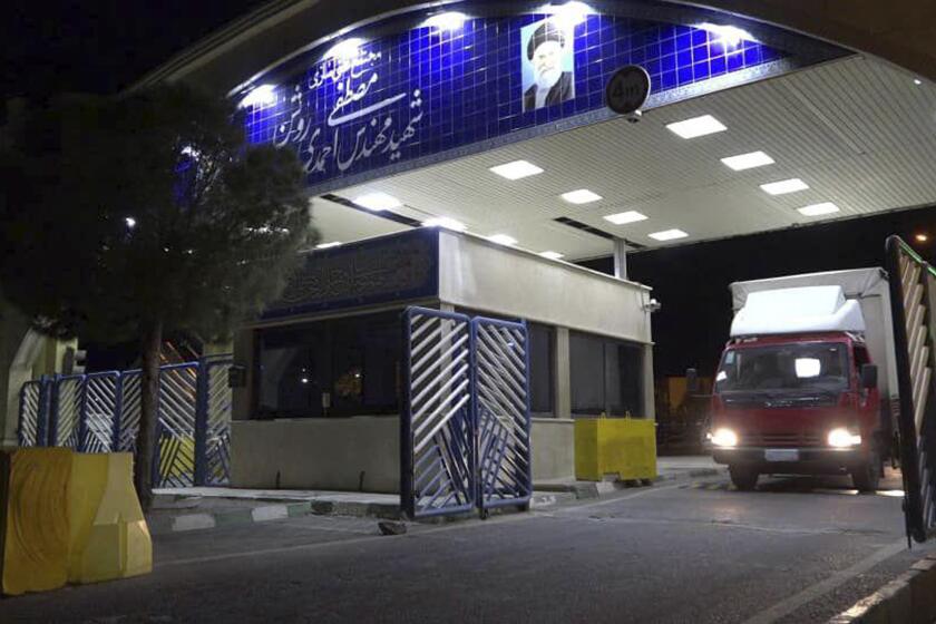 FILE - In this photo released on Nov. 6, 2019, by the Atomic Energy Organization of Iran, a truck carrying uranium hexafluoride gas leaves the Ahmadi Roshan uranium enrichment facility in Natanz, Iran, to the centrifuges at the Fordo nuclear facility. On Monday, March 14, 2022, Iranian state television reported that the paramilitary Revolutionary Guard arrested members of a "network" working for Israel that planned to sabotage Iran's major underground nuclear facility at Fordo. (Atomic Energy Organization of Iran via AP, File)