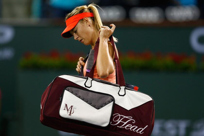 Maria Sharapova of Russia walks off the court after losing to Flavia Penetta of Italy, 3-6, 6-3, 6-2, in a fourth round match at the BNP Paribas Open at the Indian Wells Tennis Garden.