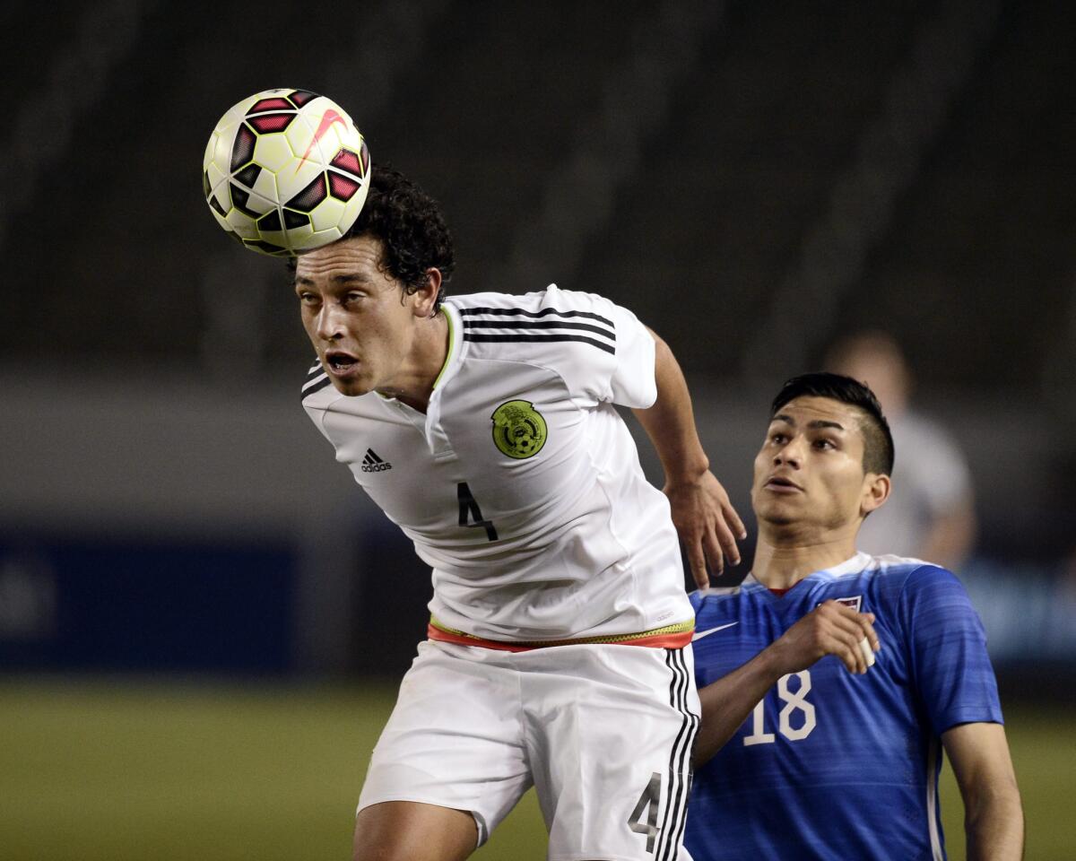 Mexico soccer player Luis Guzman keeps the ball away from Mario Rodriguez of the U.S. team during an international friendly on April 22.