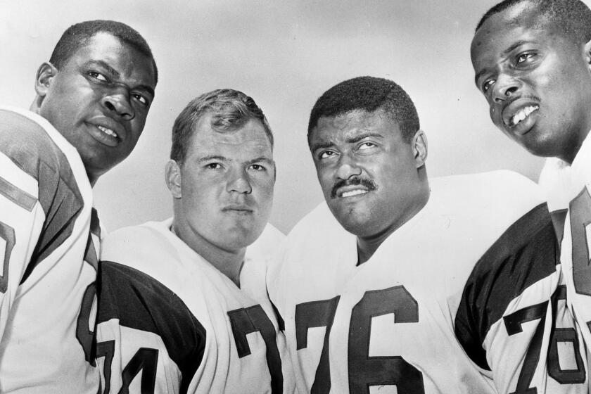 The Los Angeles Rams defensive front four, known as the "Fearsome Foursome." from left to right are Lamar Lundy (85), Merlin Olsen (74), Rosey Grier (76), and Deacon Jones (75).