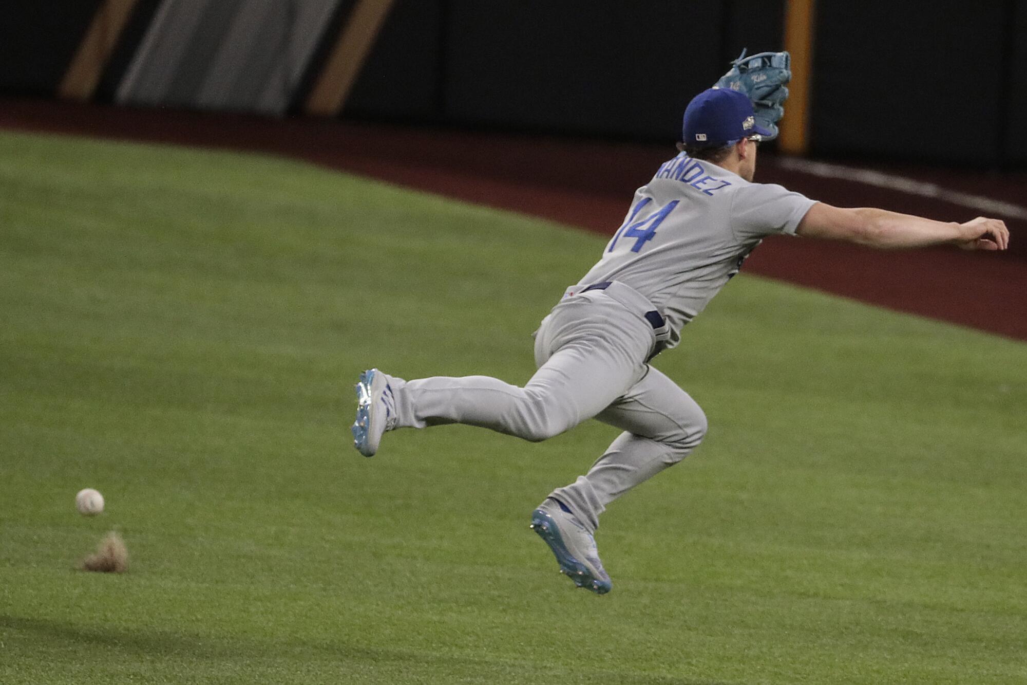 Dodgers second baseman Kiké Hernández can't grab a run-scoring single by Atlanta's Ozzie Albies.