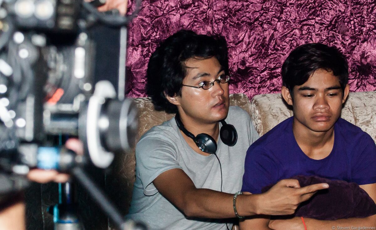 Director Davy Chou, left, on the set of the 2016 film “Diamond Island,” alongside actor Sobon Nuon.