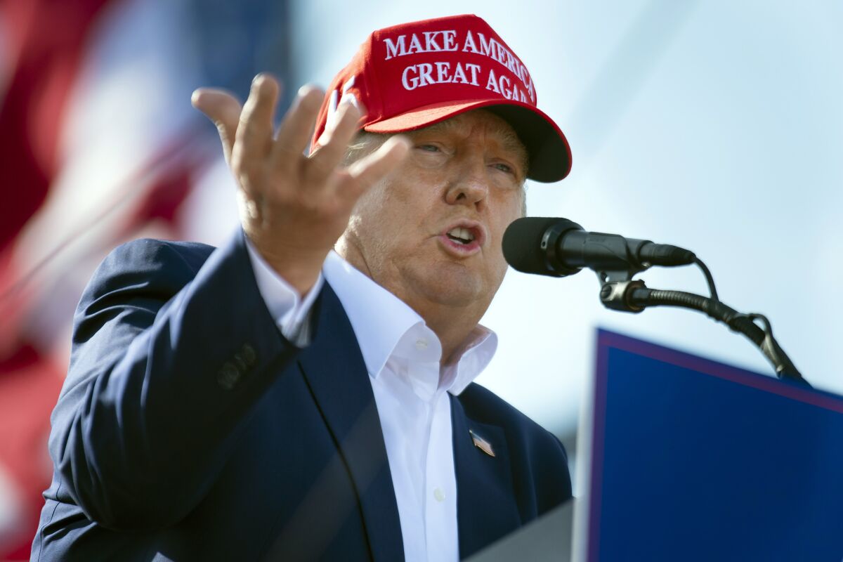 FILE — Former President Donald Trump speaks from the podium during a campaign rally, May 1, 2022, in Greenwood, Neb. A lawyer for the New York attorney general's office said Friday, May 13, 2022, that the office is "nearing the end" of its three-year investigation into Trump and his business practices. (Kenneth Ferriera/Lincoln Journal Star via AP, File)