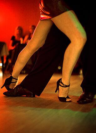 Tango dancers move very close together and their legs are often intertwined.