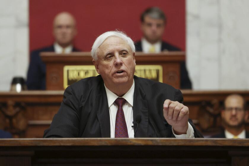 FILE - West Virginia Gov. Jim Justice delivers his annual State of the State address in the House Chambers at the state capitol in Charleston, W.Va., on Jan. 11, 2023. Justice announced Friday, April 192, 204, that West Virginia will not face a clawback of $465 million in COVID-19 money from the U.S. Department of Education, alleviating concerns raised by state lawmakers during the last days of the legislative session in March. (AP Photo/Chris Jackson, File)