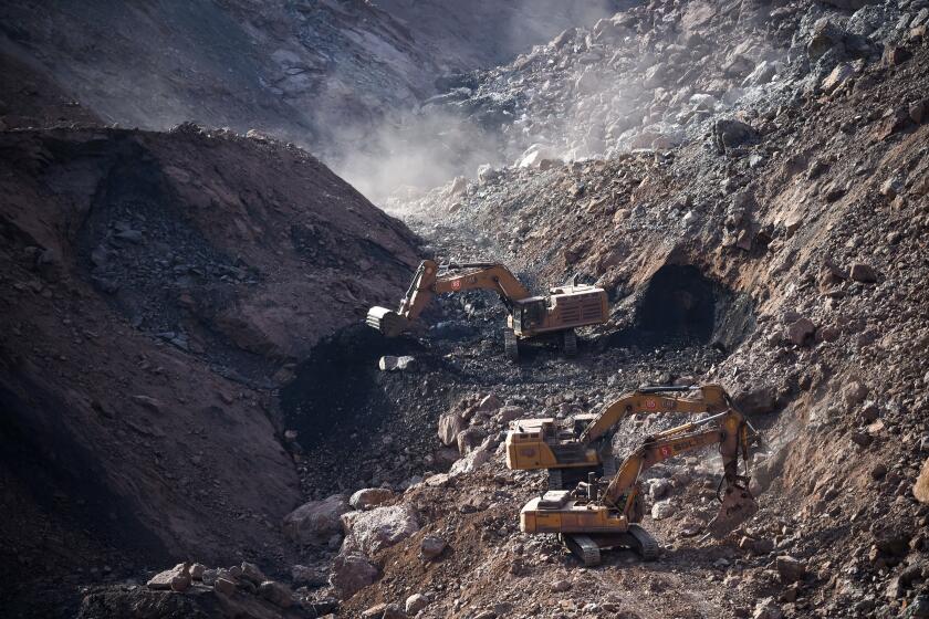 In this photo released by China's Xinhua News Agency, rescuers work at the site of a collapsed open pit coal mine in Alxa League in northern China's Inner Mongolia Autonomous Region, Thursday, Feb. 23, 2023. Rescuers with backhoes and bulldozers dug through tons of earth and rubble Thursday for dozens of people missing after a landslide buried an open-pit mine in northern China. (Bei He/Xinhua via AP)