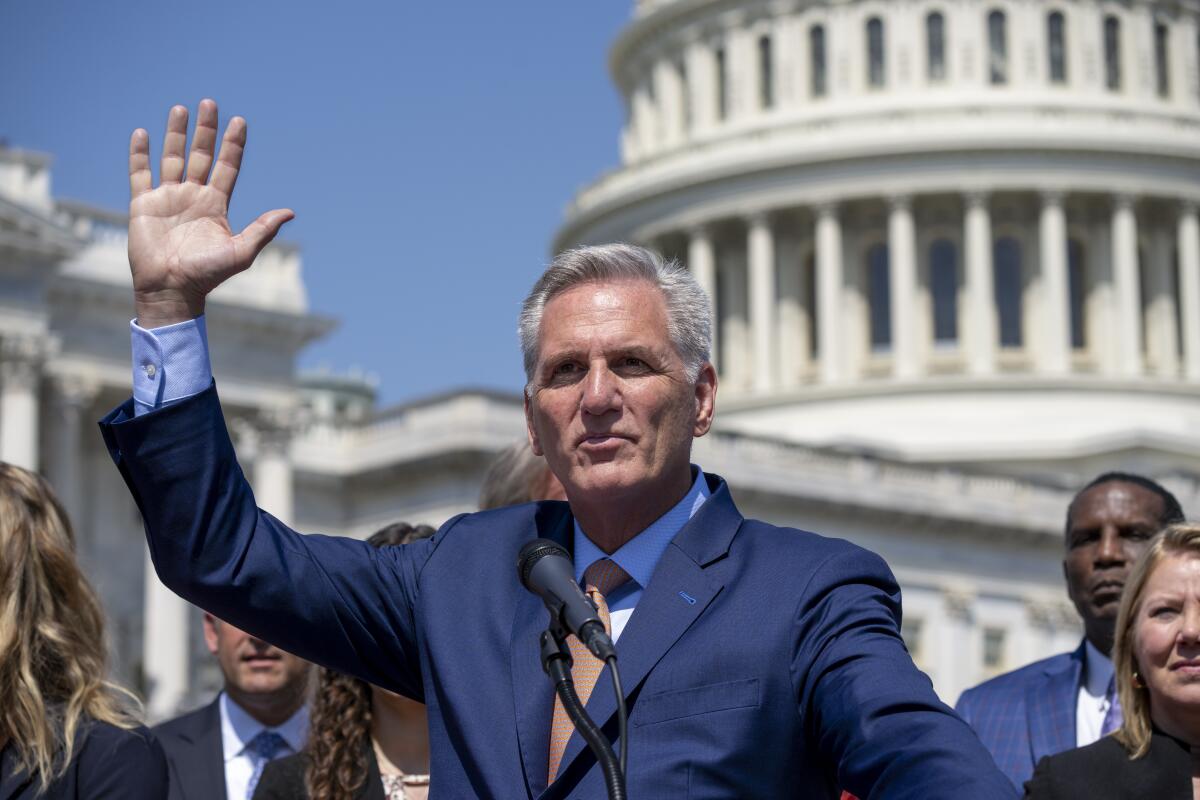 Kevin McCarthy waves in front of the Capitol.