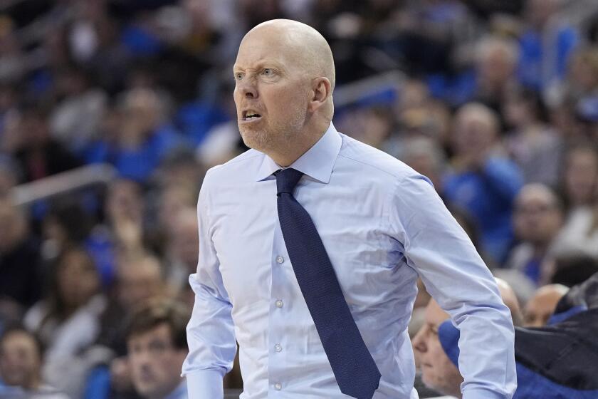 UCLA head coach Mick Cronin tosses his jacket as he yells at a referee during the first half.