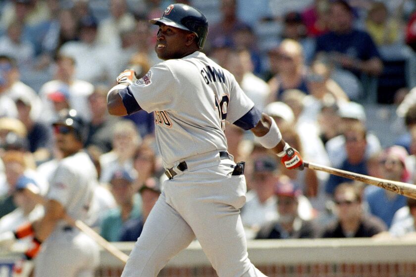 Padres outfielder Tony Gwynn follows through on an RBI double during a game against the Chicago Cubs at Wrigley Field on Aug. 7, 1994.
