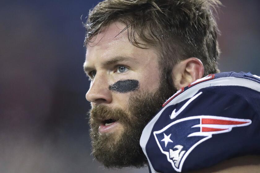 FILE - In this Dec. 12, 2016 file photo, New England Patriots wide receiver Julian Edelman waits for the start of an NFL football game against the Baltimore Ravens in Foxborough, Mass. A social media message to Edelman led police to apprehend a teenager in Michigan, in late March 2018, who posted a threat about shooting up his school. (AP Photo/Charles Krupa, File)